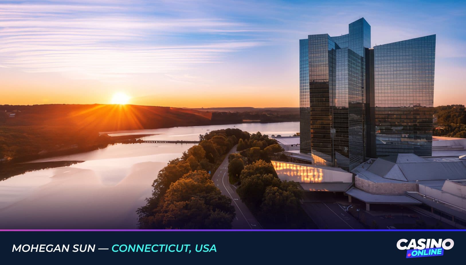 Sunrise view of Mohegan Sun in Connecticut, USA, featuring the modern glass casino hotel overlooking the Thames River and scenic forest landscape.