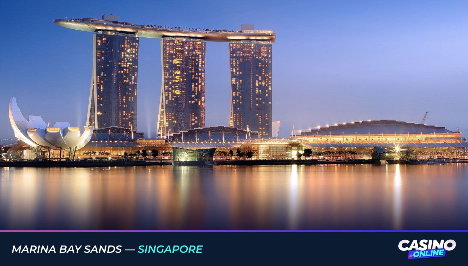 Marina Bay Sands in Singapore, featuring the three iconic towers and rooftop SkyPark illuminated against the evening sky, reflected in the waterfront.