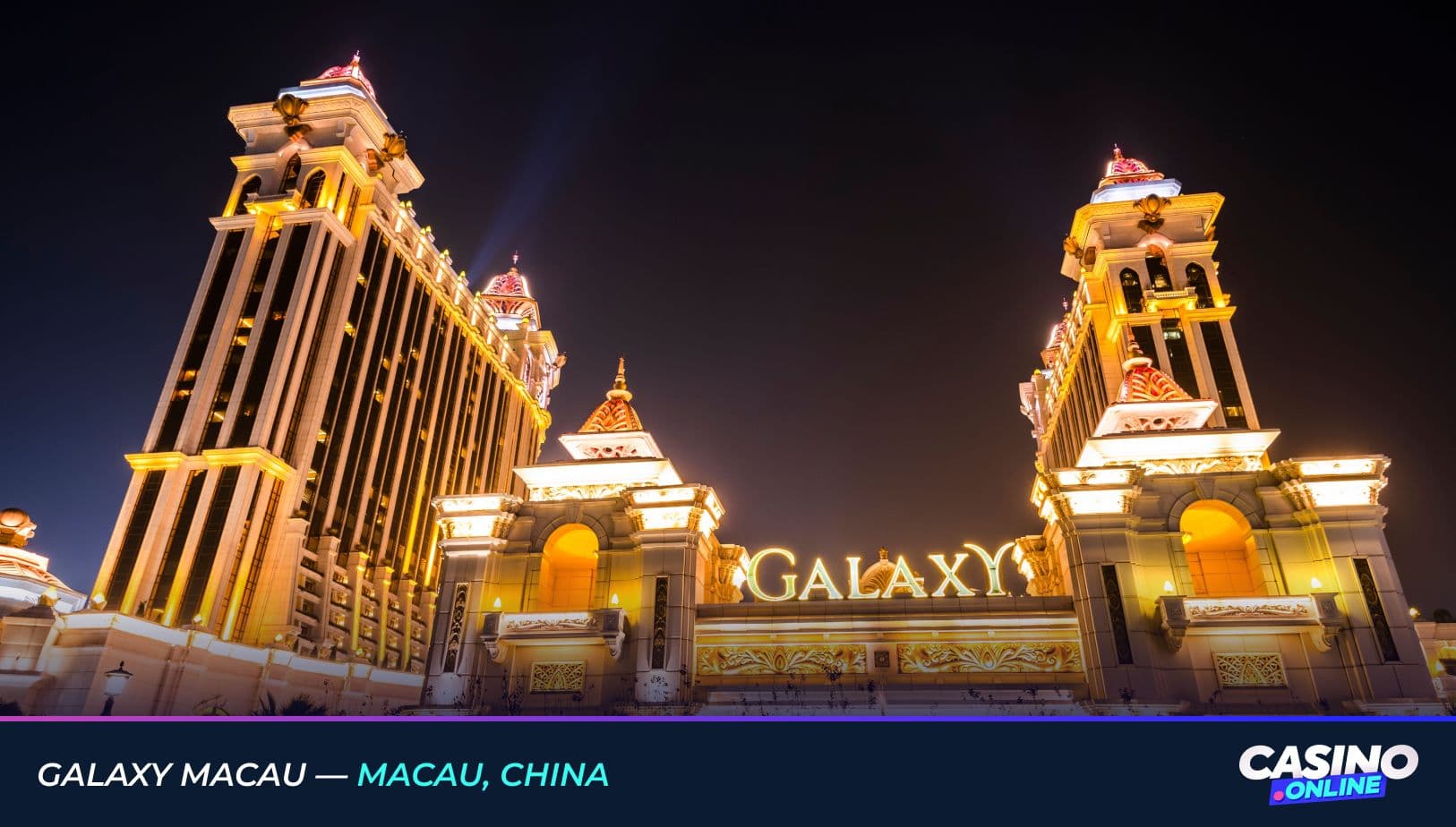 Illuminated night view of Galaxy Macau in Macau, China, showcasing the grand entrance and two ornate, golden-lit towers.