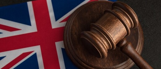 A gavel on top of the Flag of the UK.